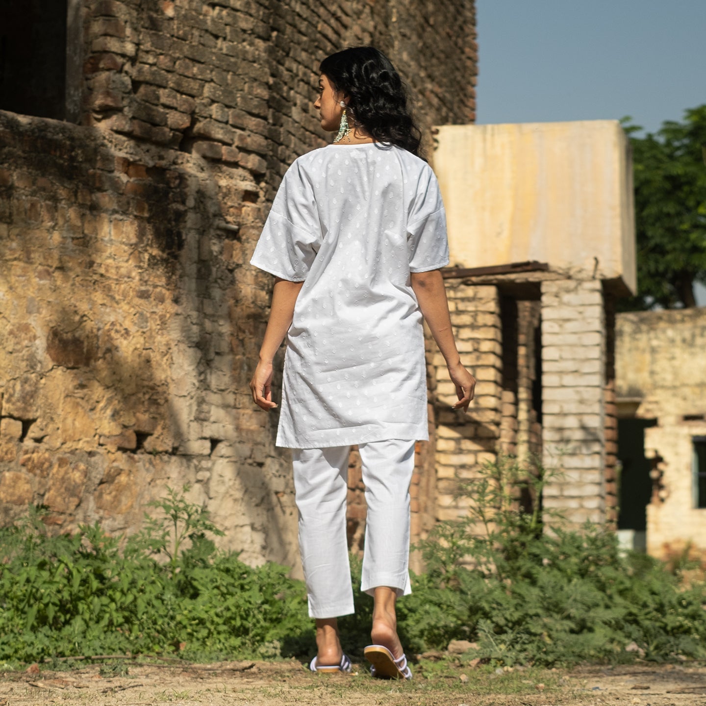 White Oversized short kurta with side slits paired with cigarette pants sets Set