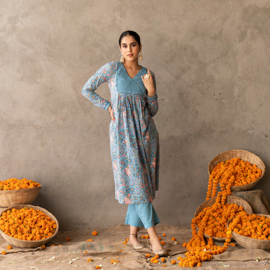 Blue block printed with yoke and sleeve detailed A line kurta paired with blue solid straight pants set