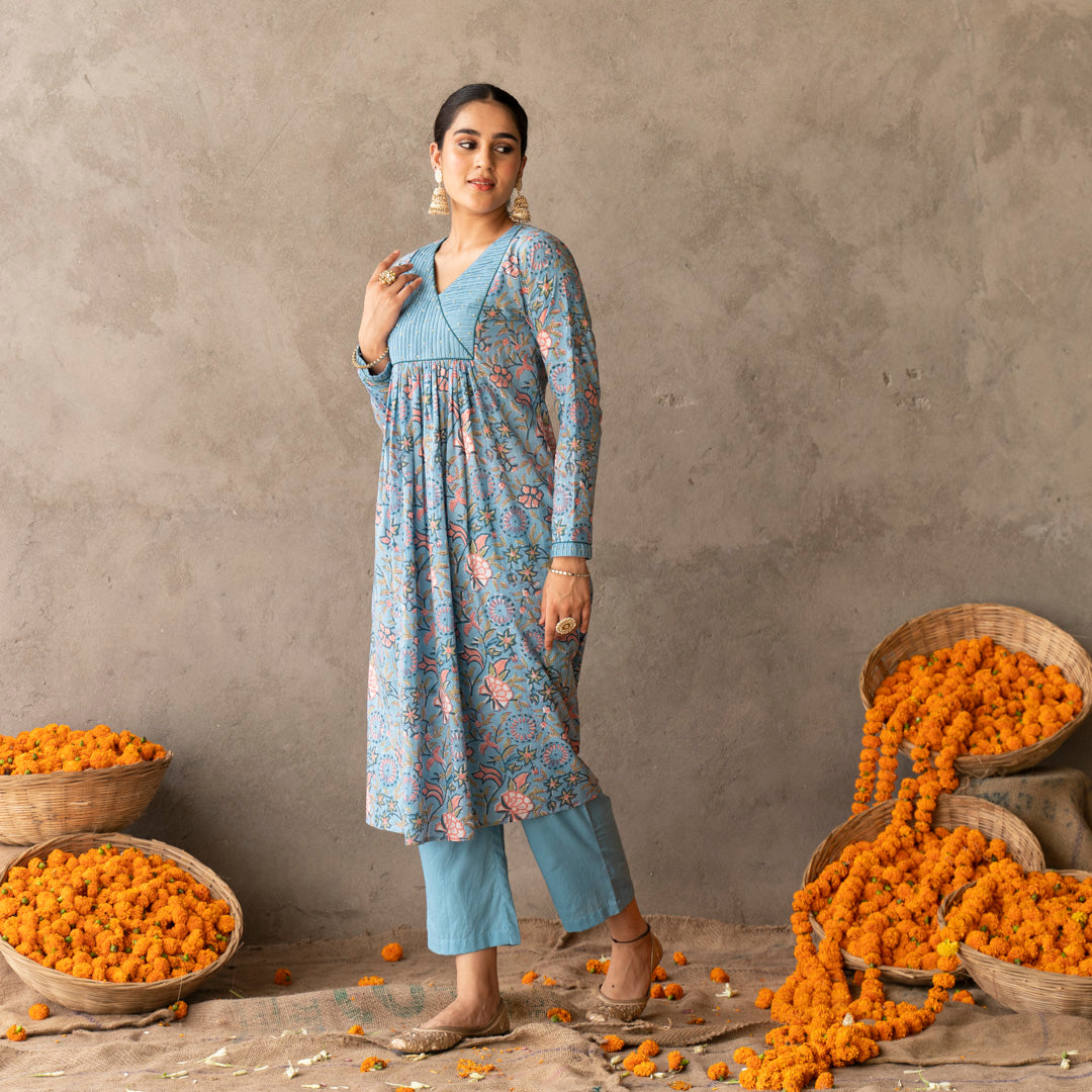 Blue block printed with yoke and sleeve detailed A line kurta paired with blue solid straight pants set