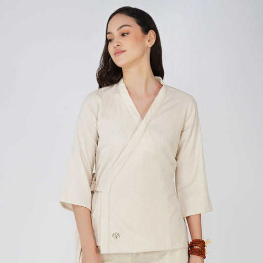 Woman wearing a beige kimono-style outfit on a white background