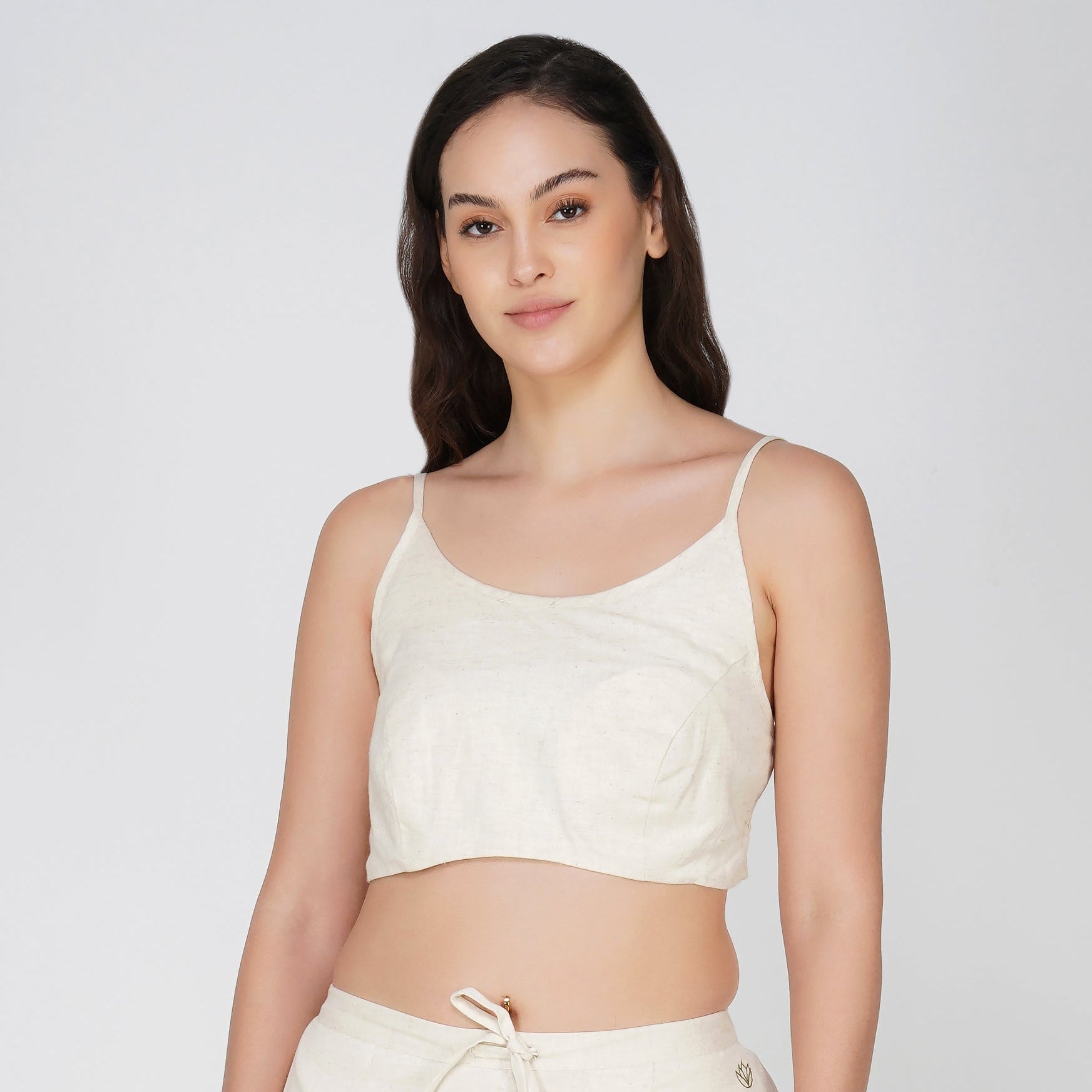 Woman wearing a white outfit on a plain background