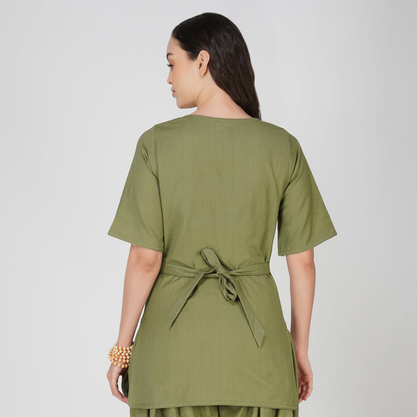 Woman wearing a green outfit on a white background