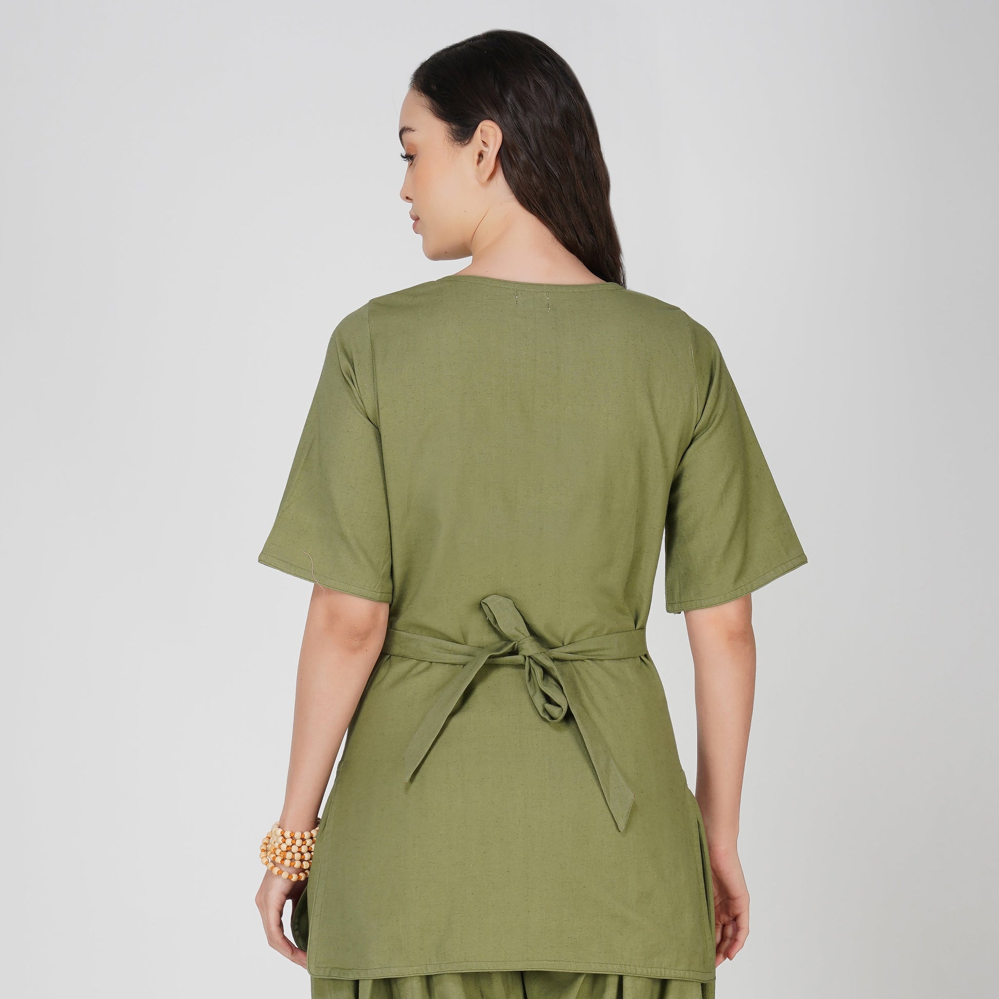 Woman wearing a green outfit on a white background