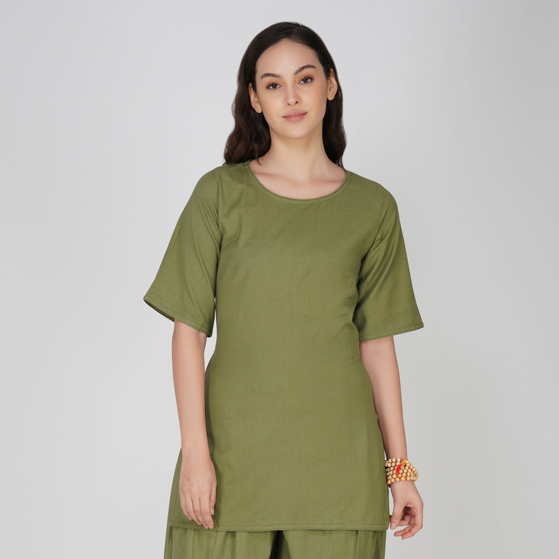 Woman wearing a green outfit on a white background