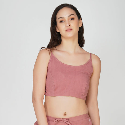 Woman wearing a pink crop top on a white background