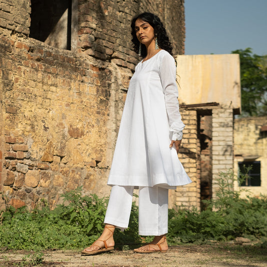 White Cotton round neck knee length Anarkali style Kurta paired with palazzo pants
