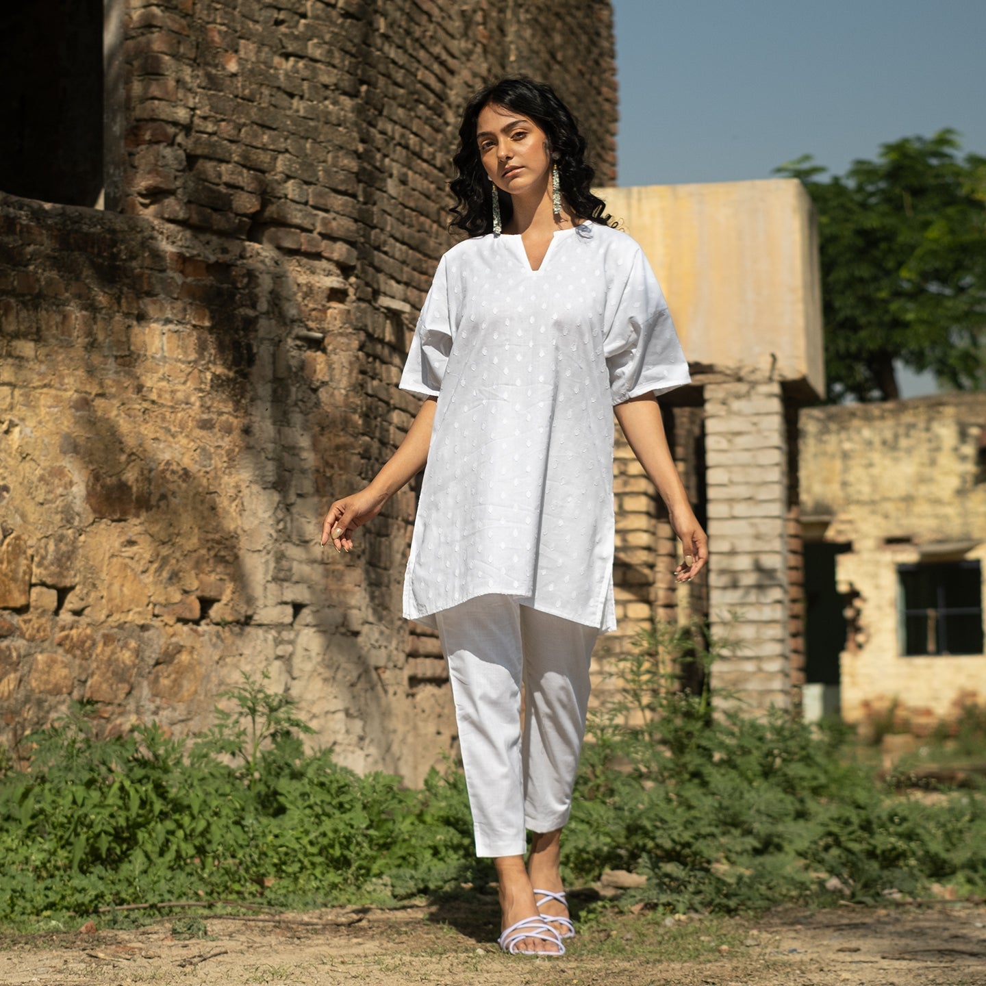 White Oversized short kurta with side slits paired with cigarette pants sets Set