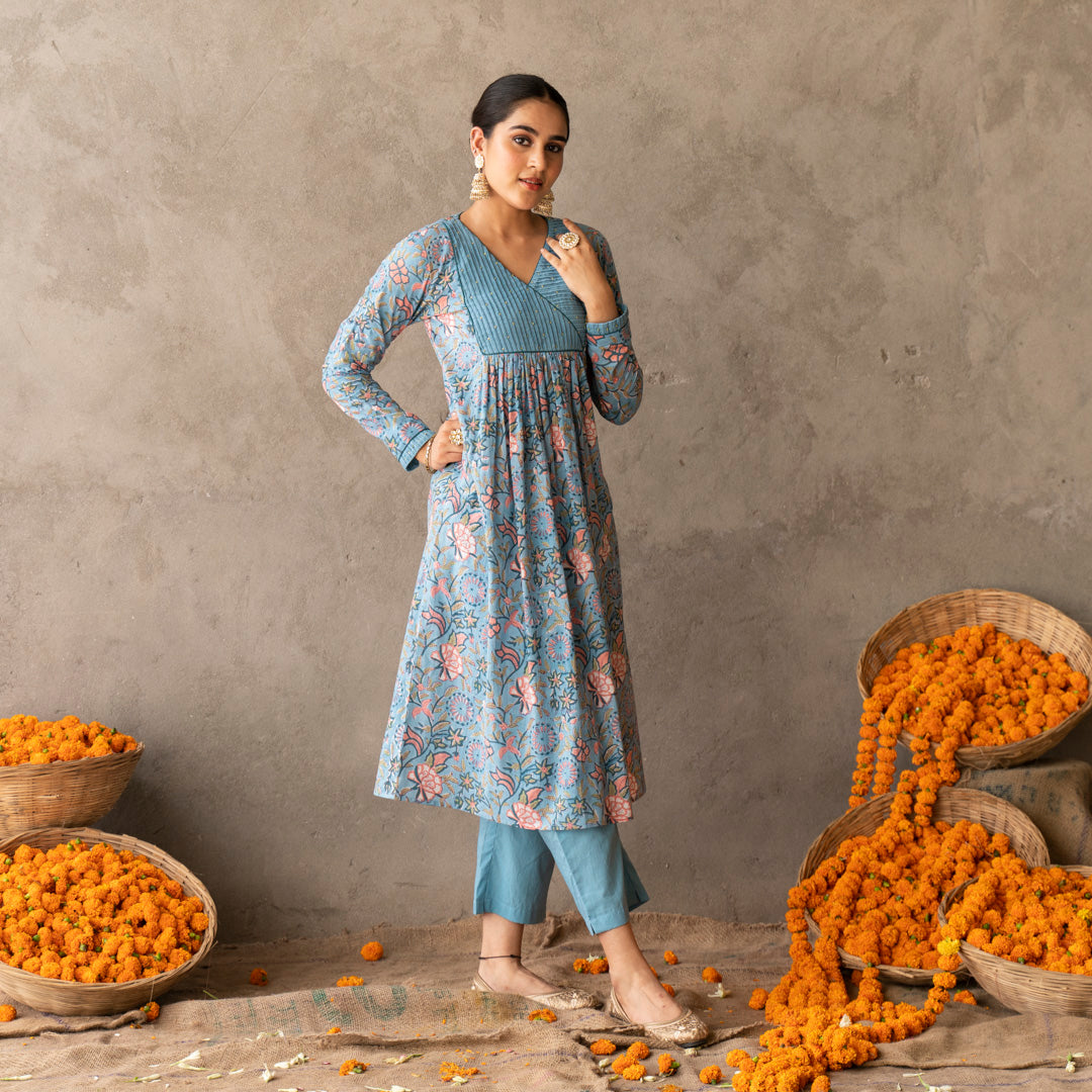 Blue block printed with yoke and sleeve detailed A line kurta paired with blue solid straight pants set