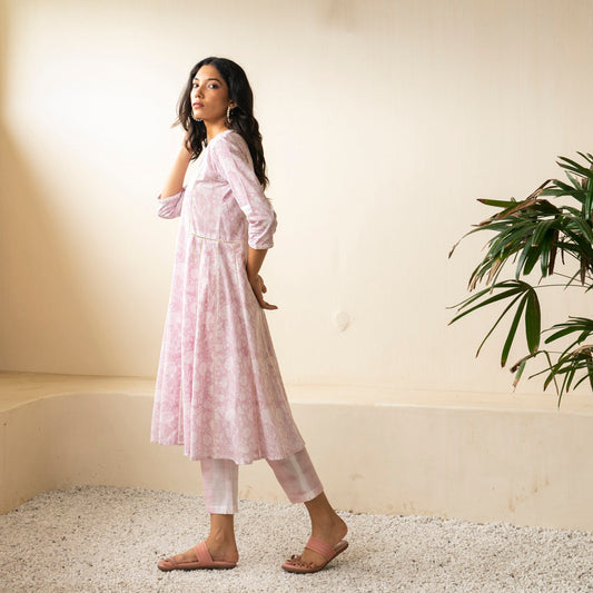 Blush pink block printed Anarkali kurta with embroidery detail neckline paired with shibori tie dye trousers set