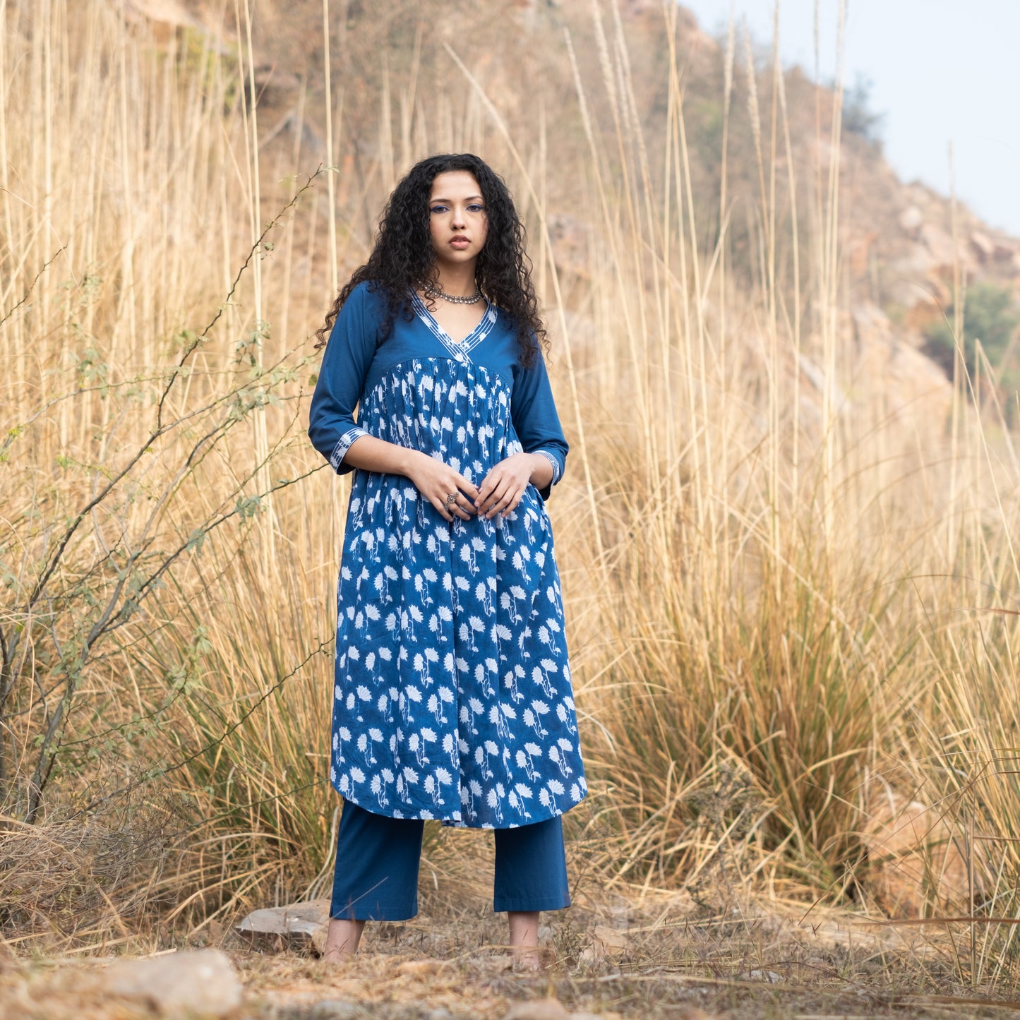 Indigo block printed gathered kurta with V Neck embroidered neckline and solid indigo pants (set of 2)