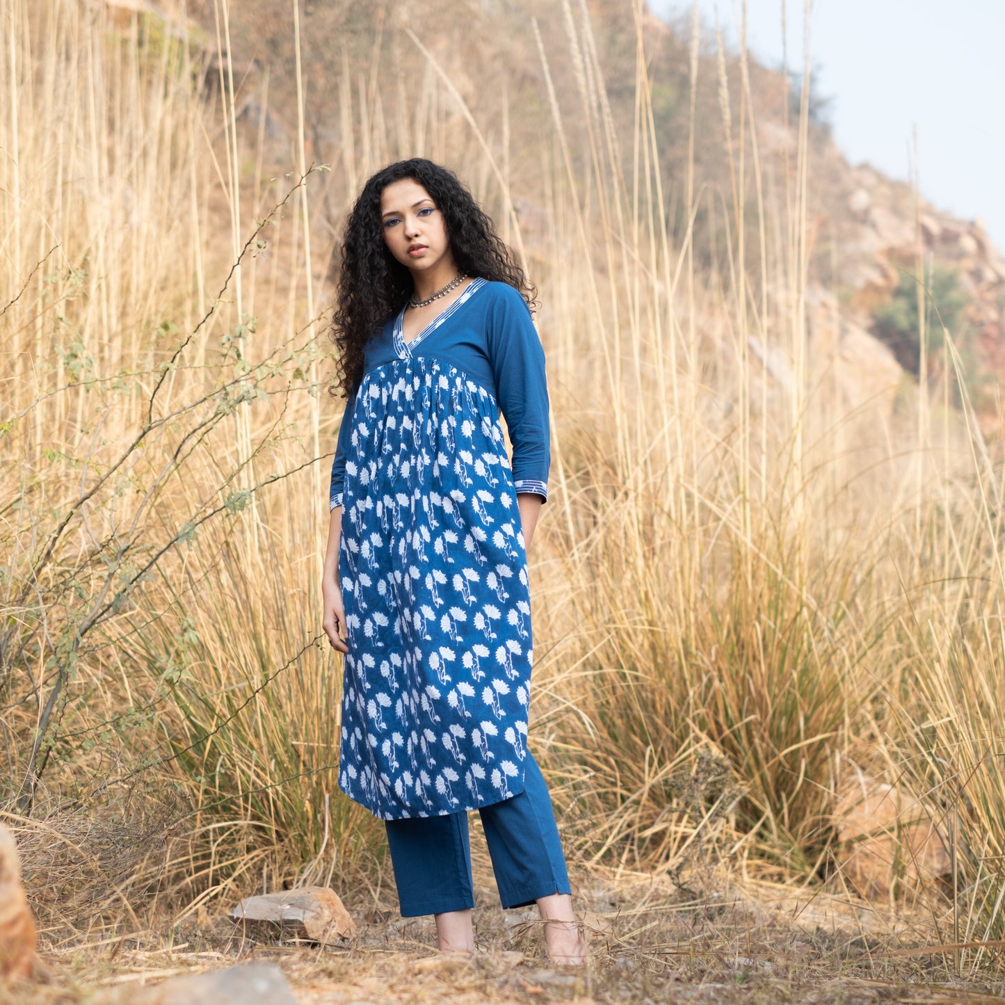 Indigo block printed gathered kurta with V Neck embroidered neckline and solid indigo pants (set of 2)